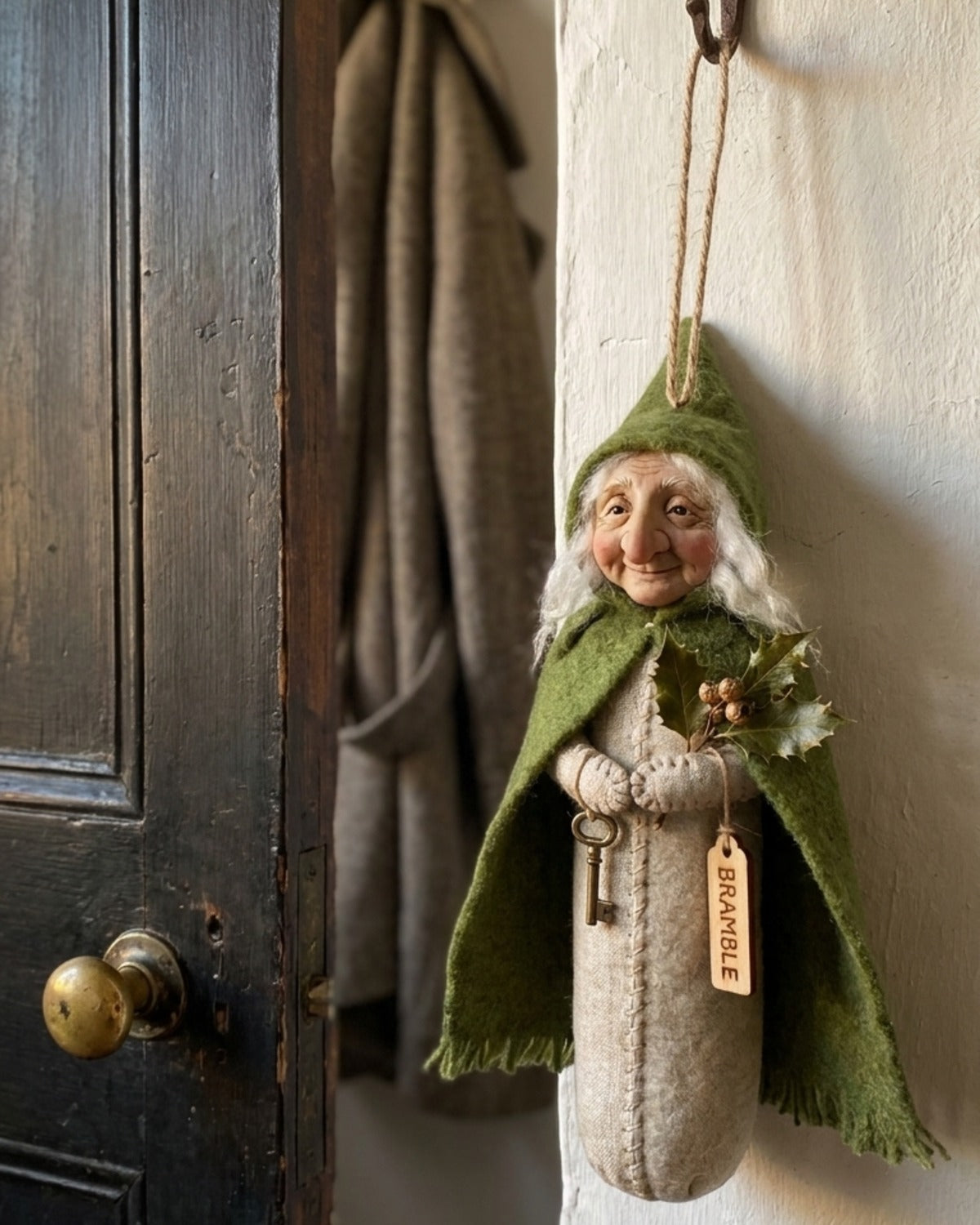 Bramble, keeper of the door, hanging beside a dark wooden front door