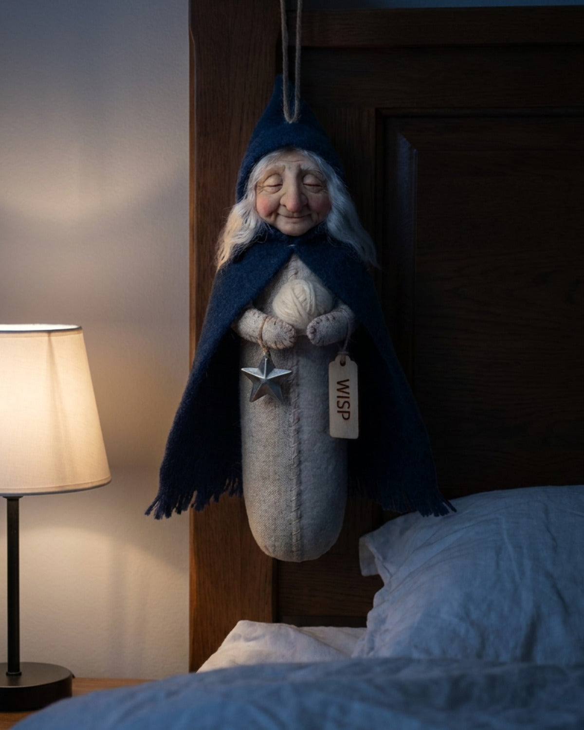 Wisp, keeper of sleep, hanging at the head of a bed at night